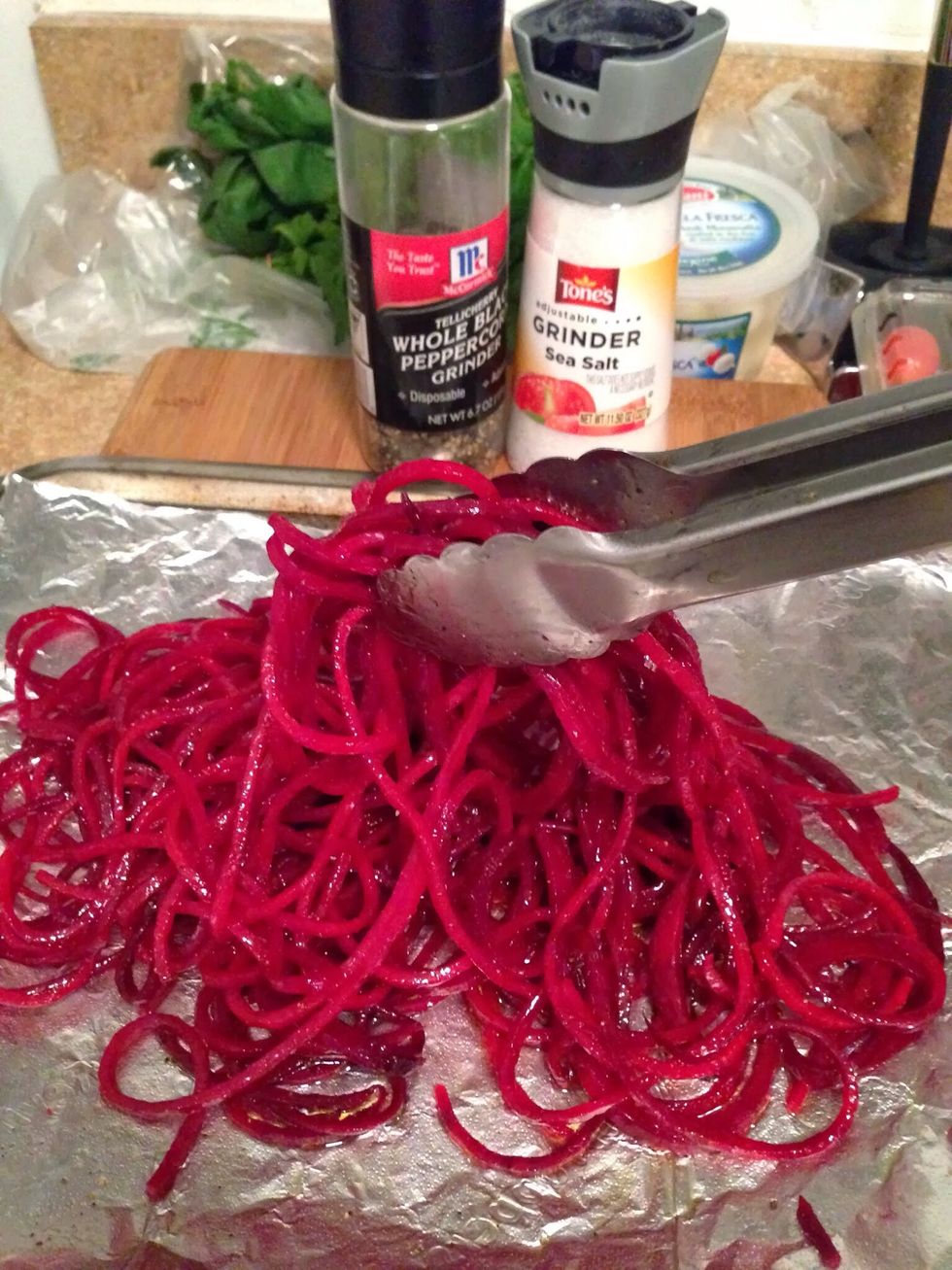 Place the beet noodles on a baking tray lined with foil. Drizzle with olive oil & season with sea salt & black pepper. Toss to combine.