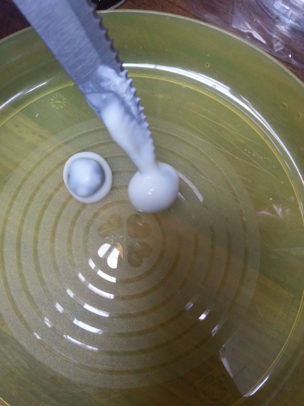 Place the blueberries on a plate after dipping them