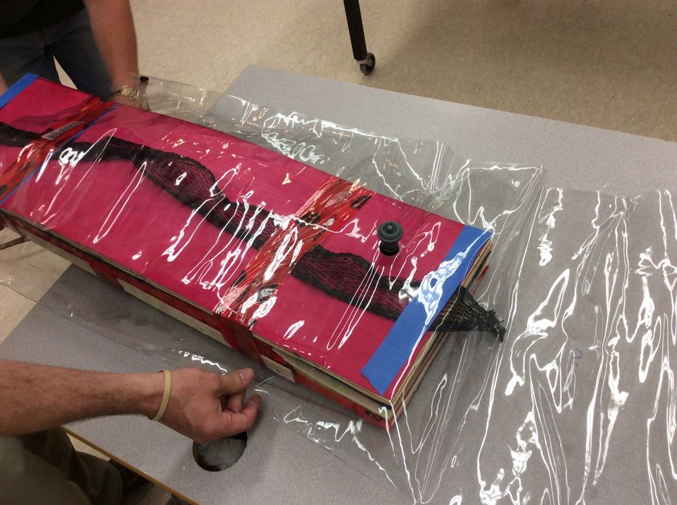 Place the board in the centre of the bag make sure to try to keep the pump valve centred and sitting right above the breathing strip.