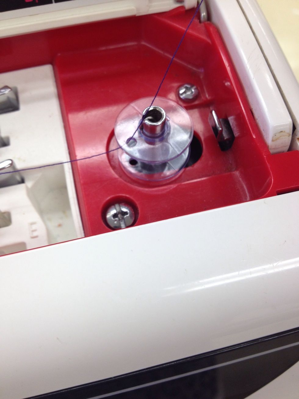Place the bobbin in the top of the machine.