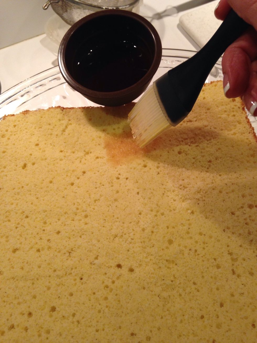 Place the bottom layer on a serving platter. Using the syrup of your choice, brush it onto the bottom layer.