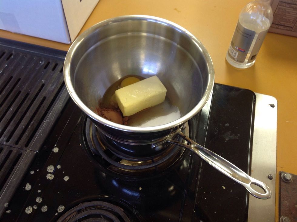 Place the bowl over the small pot that is on the heat. It is very important to watch the temperature of the food because if it gets to hot the egg will scramble.
