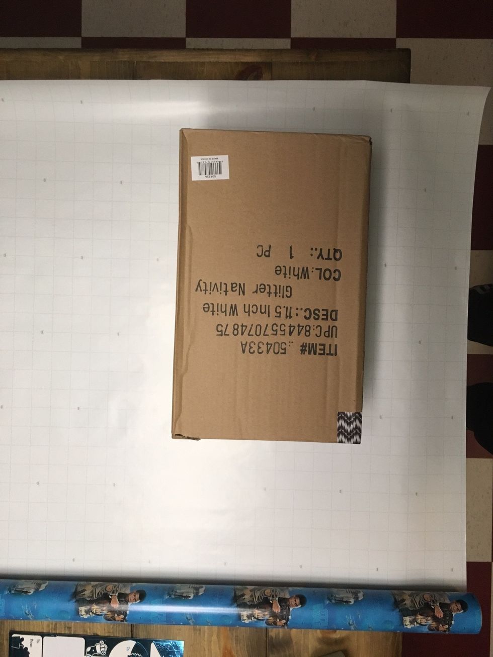 Place the box on the wrapping paper. Measure so it's even on both sides of the box.
