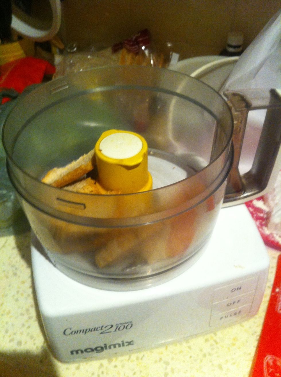 Place the bread into a blender or food processor