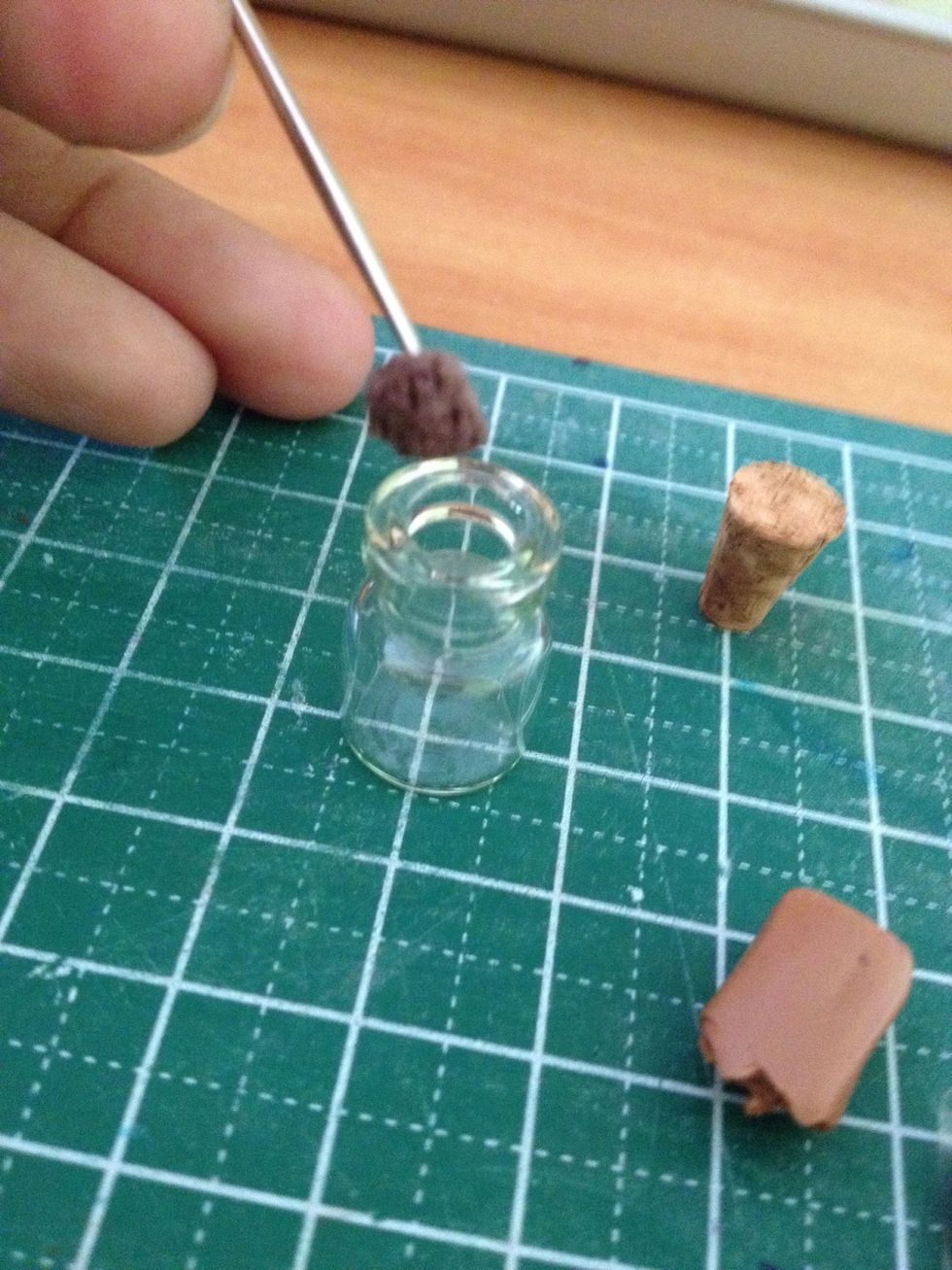 Place the brown textured piece into the jar.