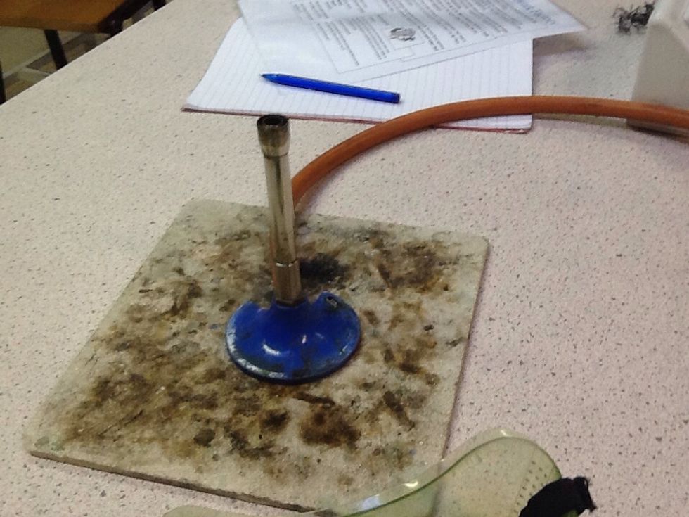 Place the Bunsen burner on the heatproof mat and don't turn the gas supply on yet