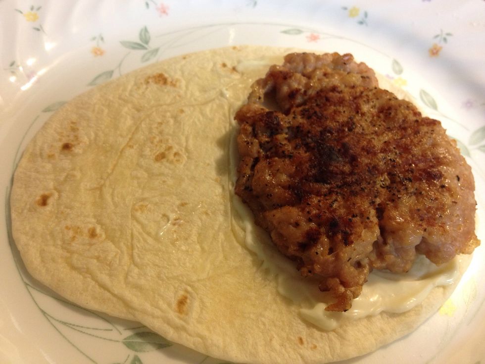 Place the burger on top. (If using a big tortilla, place 2 burgers side by side. If small tortilla, cut the burger in half and place next to each other).