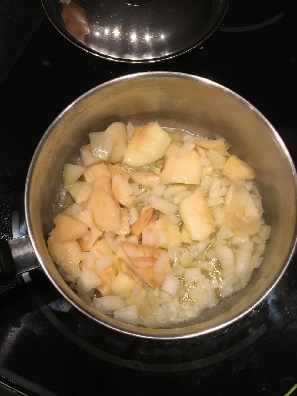 Place the butter in a large saucepan on medium heat until melted. Add the onion and apple, and lower the heat to low. Cover and cook for 10 minutes.