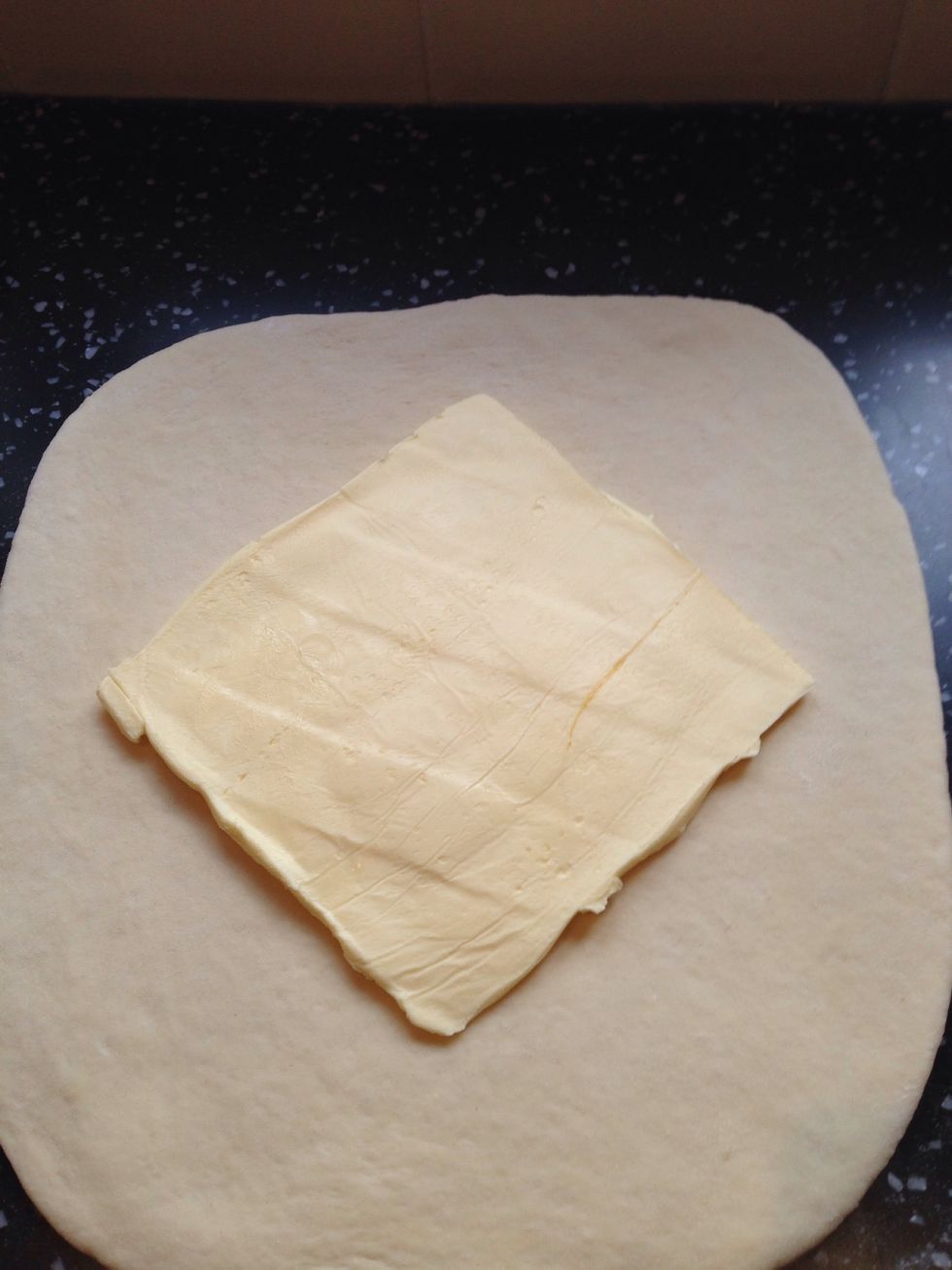 Place the butter slab on the dough at a 45 degree angle so that one if it's corners is facing you.