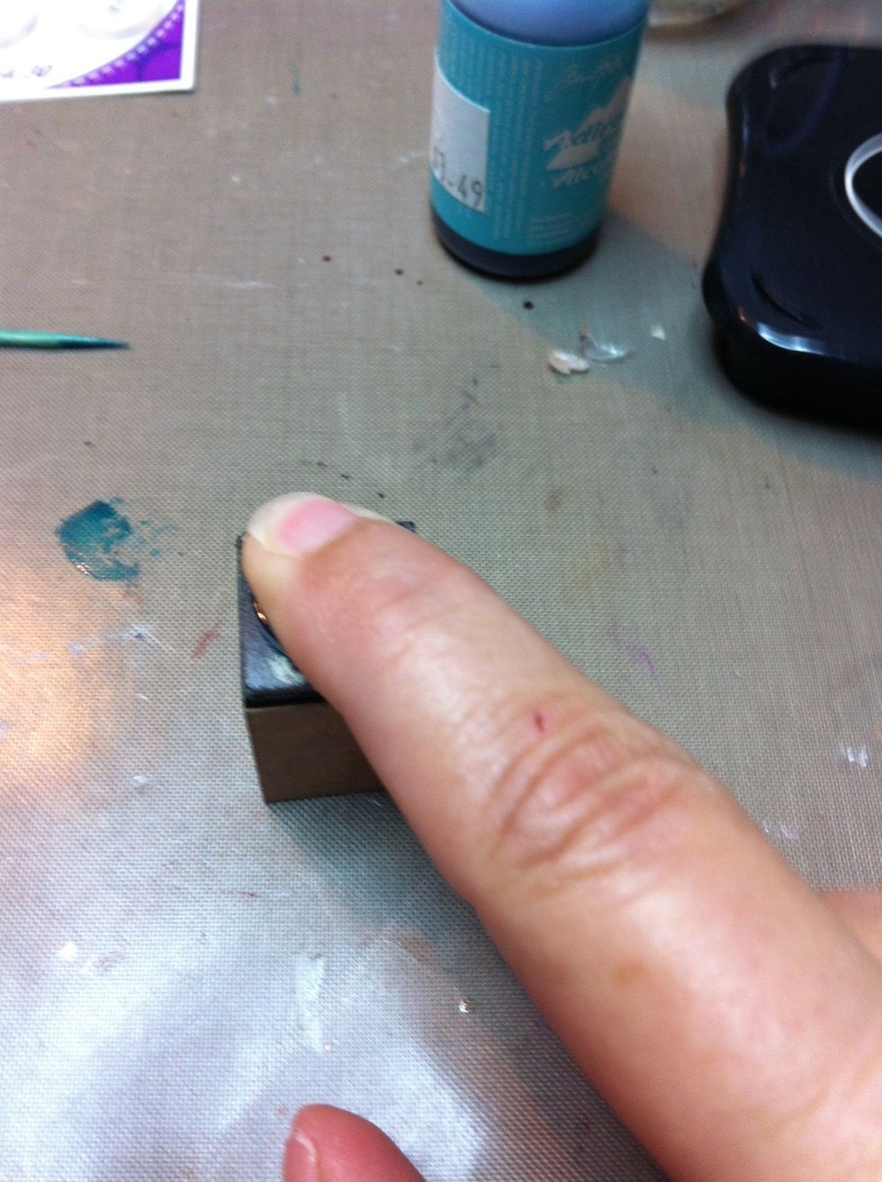 Place the button on the stamp and press firmly. Try not to move the button in any direction but down as you don't want smears.