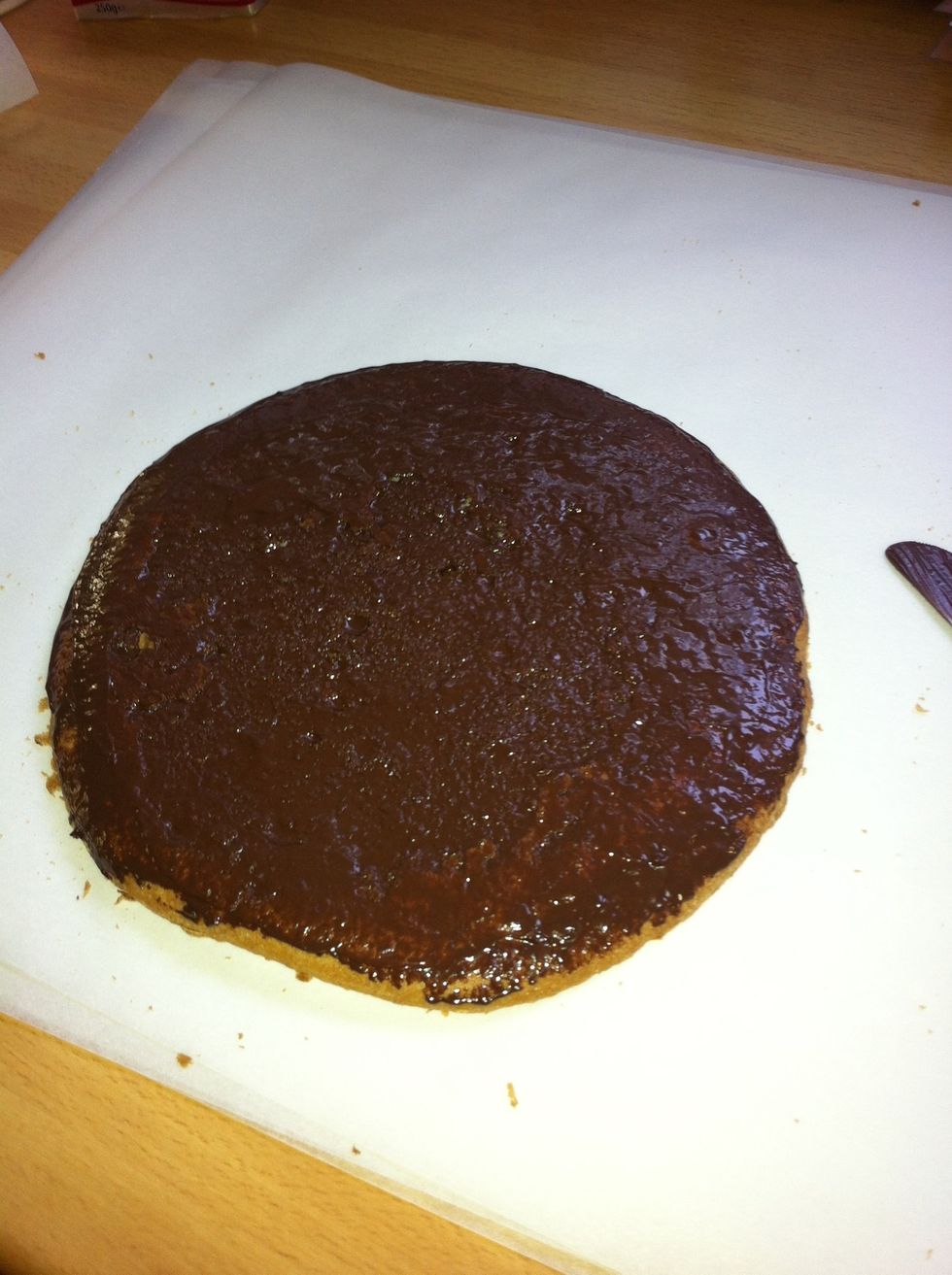 Place the cake bottoms on pieces of wax paper. Spread the chocolate evenly on all the cake bottoms. I use a butter knife. It is almost like making a sandwich :)