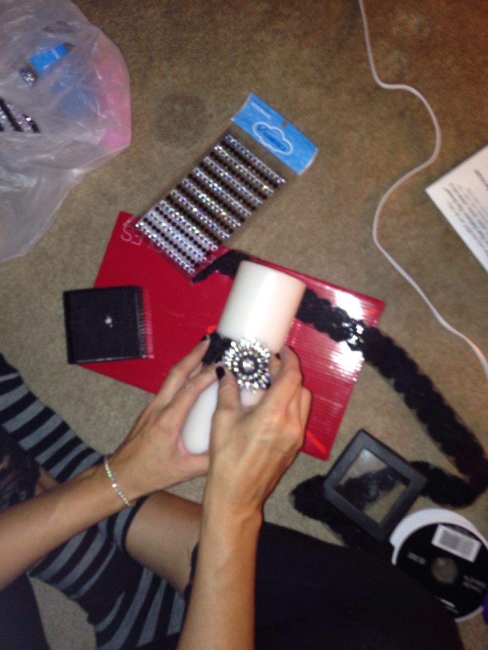 Place the candle through the ribbon