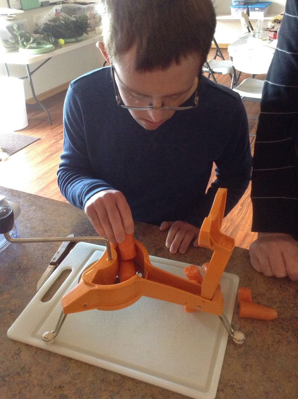 Place the carrot pieces into the grater