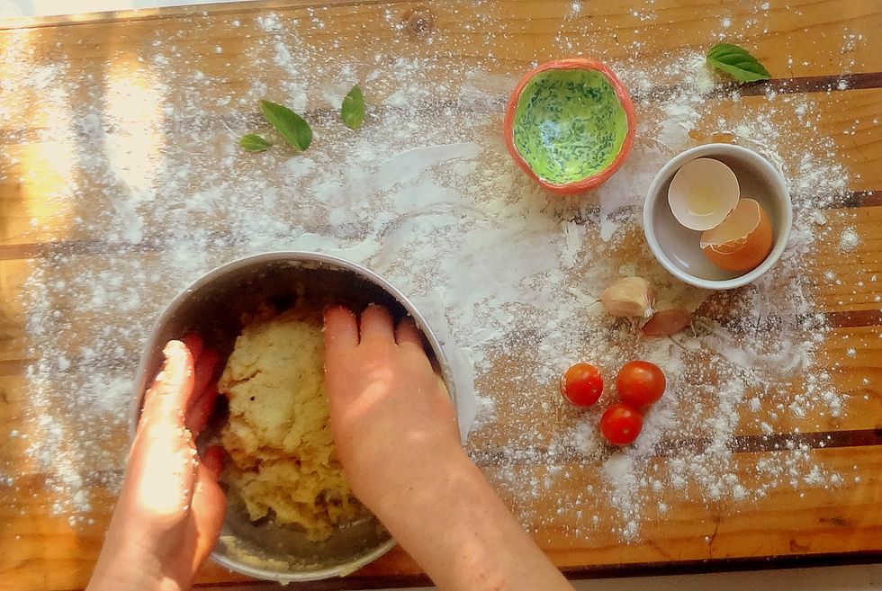 Place the cauliflower crumbs in a large mixing bowl. Add the egg, mozzarella, oregano, garlic, salt and pepper (and parmesan and chilli if desired). Mix well. The dough should feel loose and sticky.