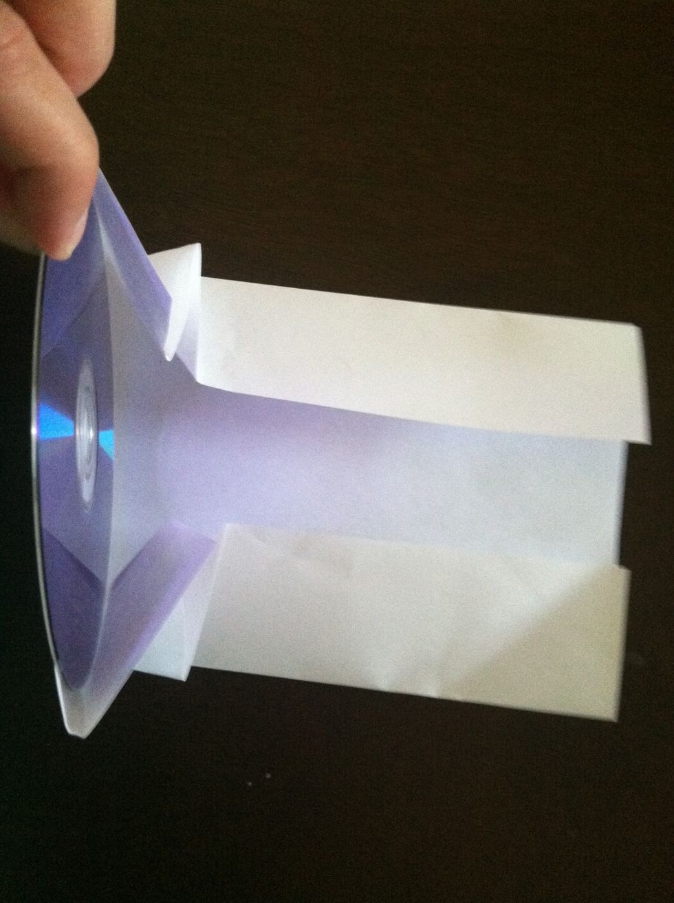 Place the cd in between the fold and the front edge