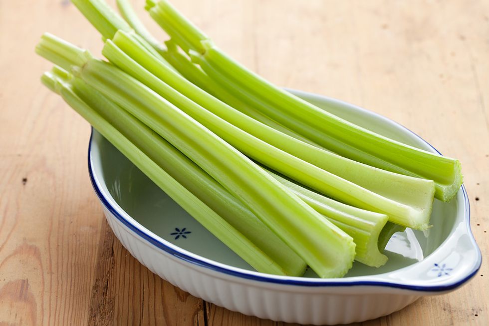 Place the celery stalks on your cutting board and pick up the knife in which you have chosen.