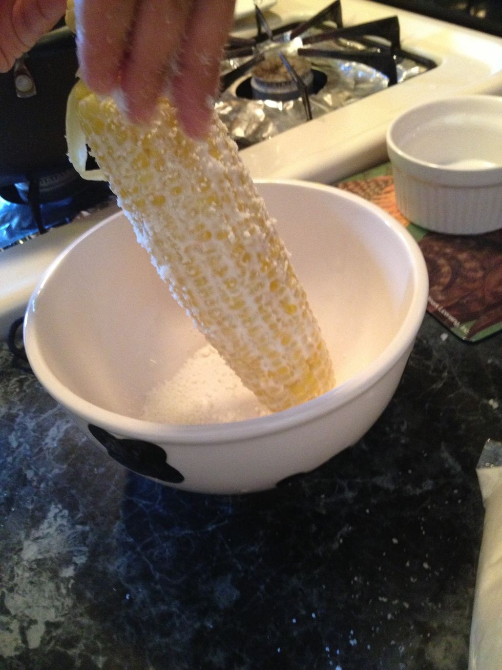 Place the cheese in a bowl and put the corn in it. Slather on the cheese as little or as much as you want.