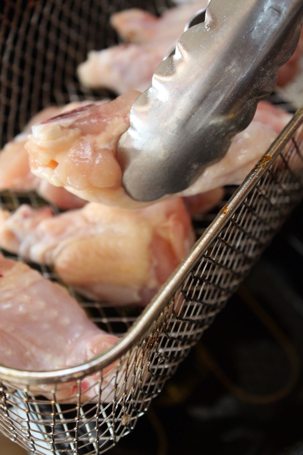 Place the chicken in the fryer. Don't overcrowd the basket for best results.