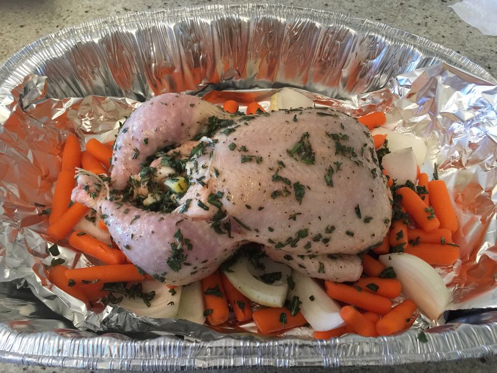 Place the chicken on the bed of vegetable and apply the herbs mix all over the chicken (back and front)