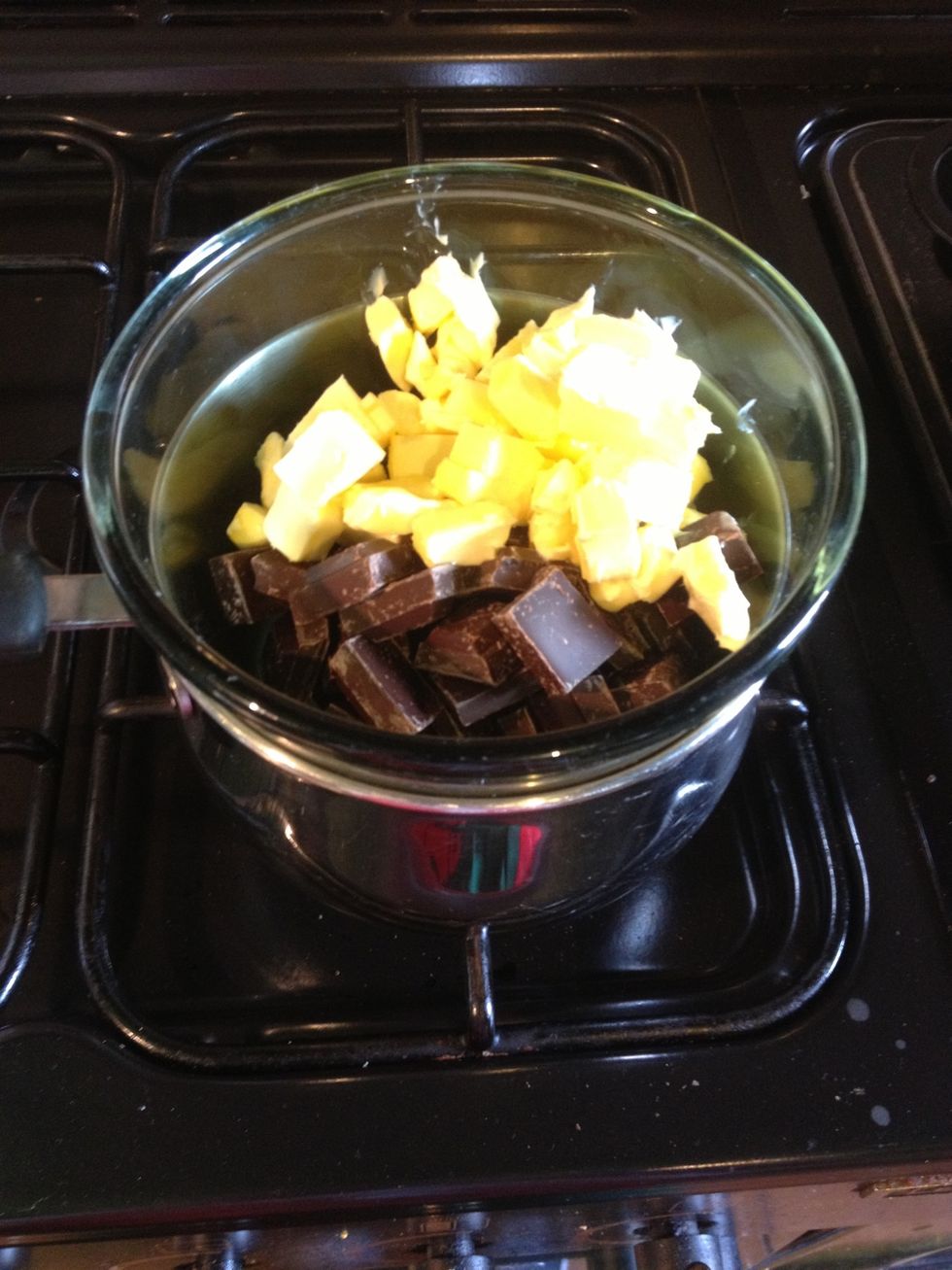 Place the chocolate and butter over a banne Marie on a very low setting (just barely giving off steam).  Do not let the water touch the bowl. Very slowly melt the chocolate and butter together.