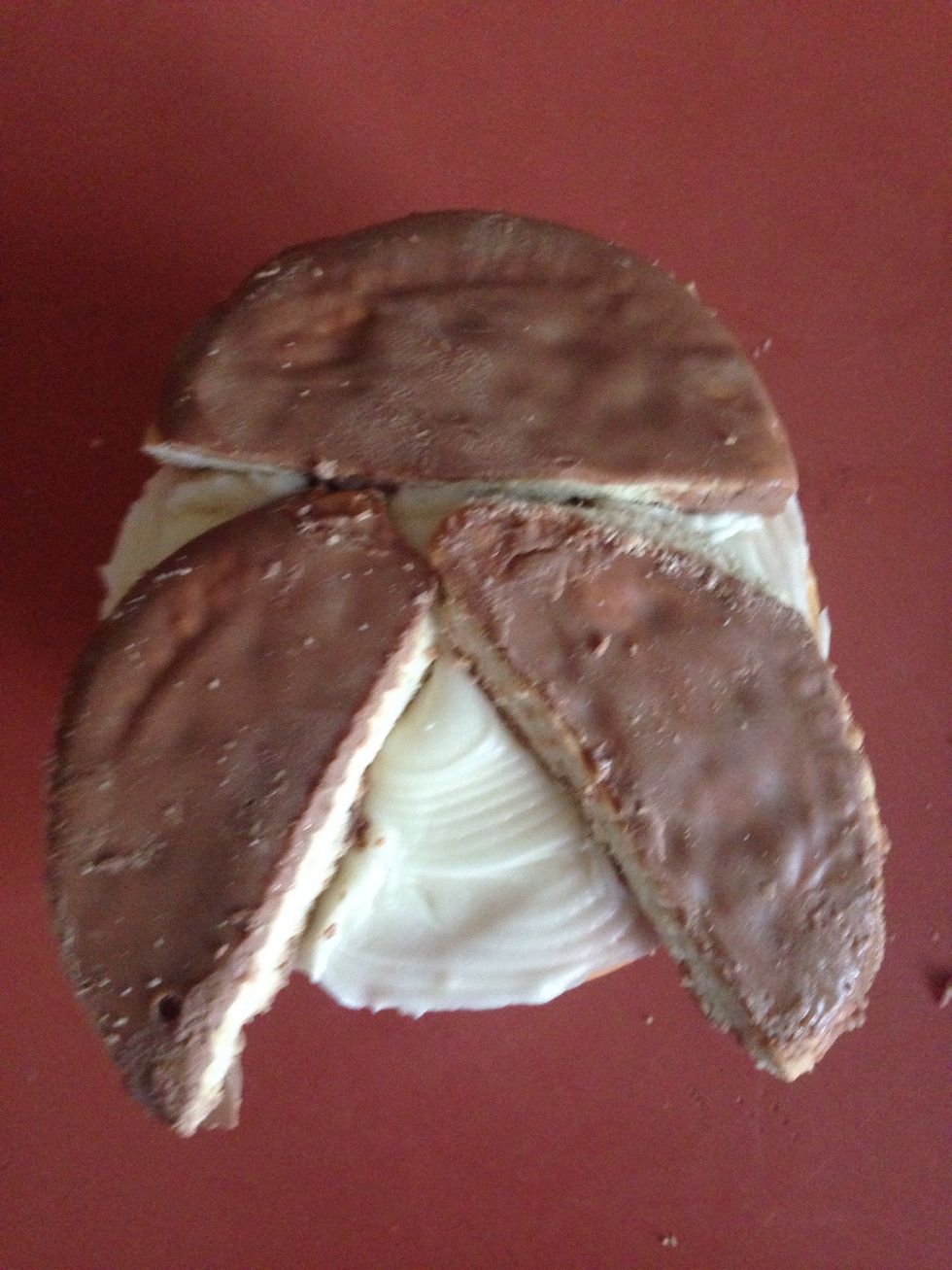 Place the chocolate covered biscuits on the cupcake! Use one at the top as the head and then add two off the top one as the owls wings.