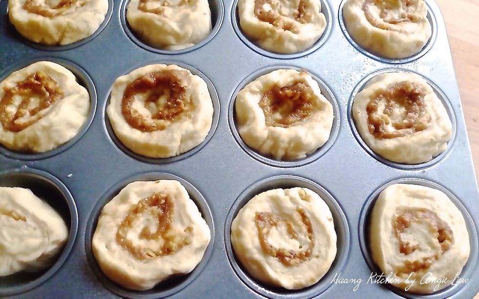 Place the cinnamon rolls, cut side up into the prepared muffin cups.