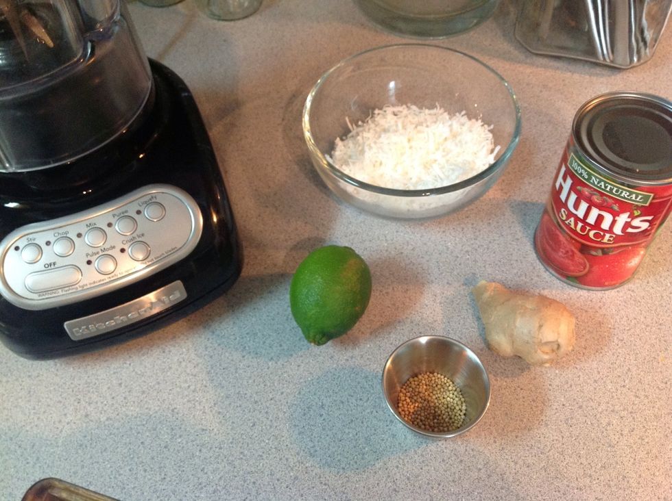 Place the coconut, mustard seeds and tomato sauce in the blender. Peal and chop the ginger and juice the lime, then and those to.