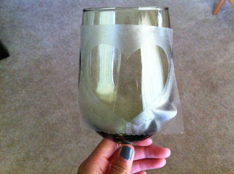 Place the contact paper onto the wine glass, positioning it to your liking. Smooth out air bubbles around the image.