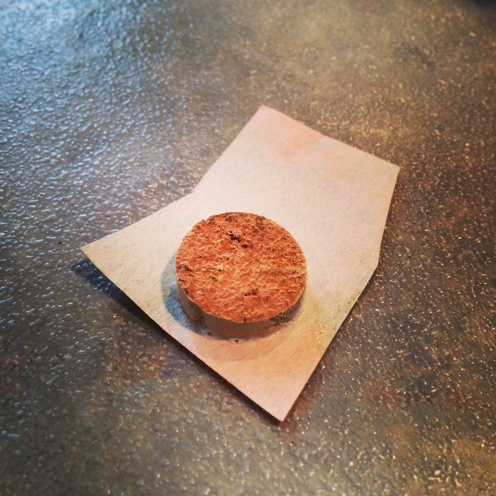 Place the cork onto the back of your paper then rub the paper into the cork. Let the glue dry.