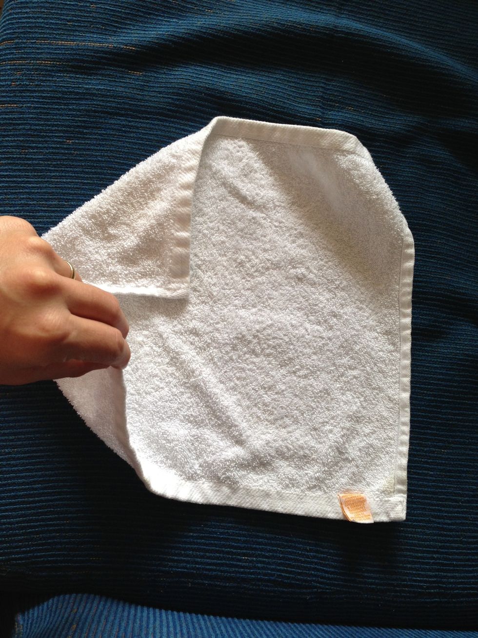 Place the corners of the towel to the center of it forming a square...
