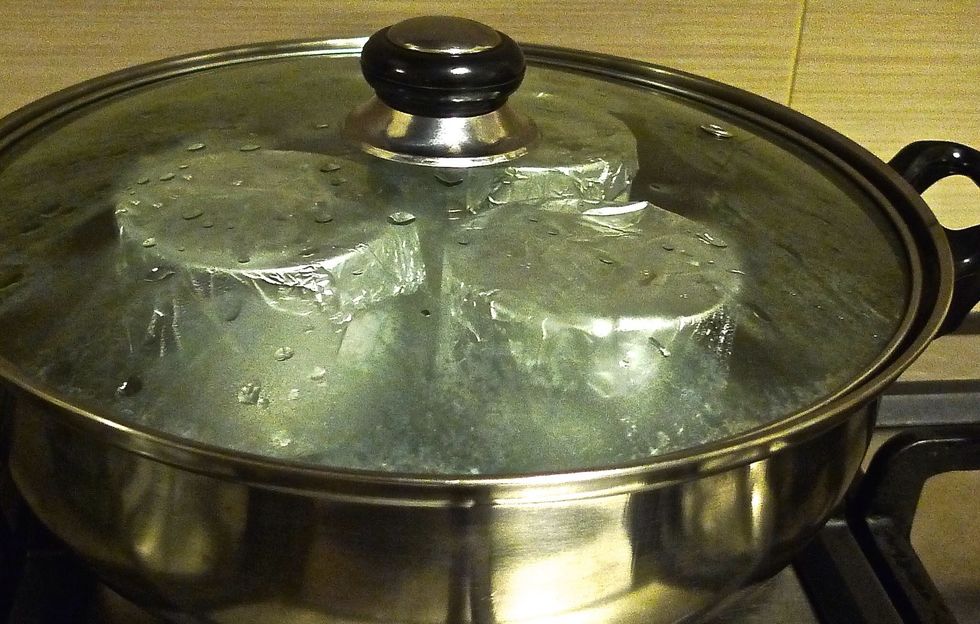 Place the covered cups gently into steaming pot and cover the pot. Cook for about 15-20 minutes on the lowest heat. Check for doneness ( skewer inserted in the centre of custards come put clean ).