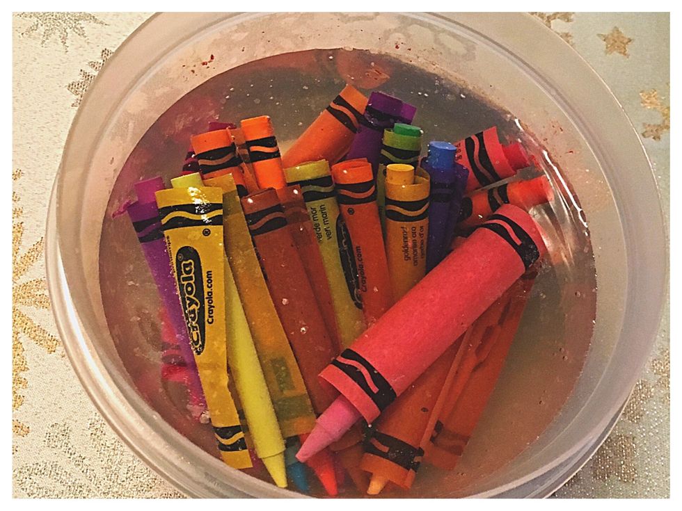 Place the crayons in a bowl filled with steaming water for 20 minutes. The water will easily remove the wrapper from the crayons.