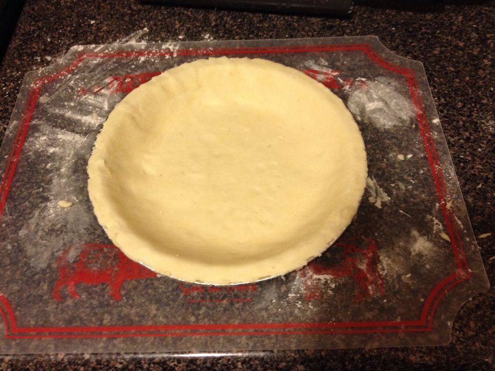 Place the crust into the pan, pressing firmly. Peel off any excess crust!