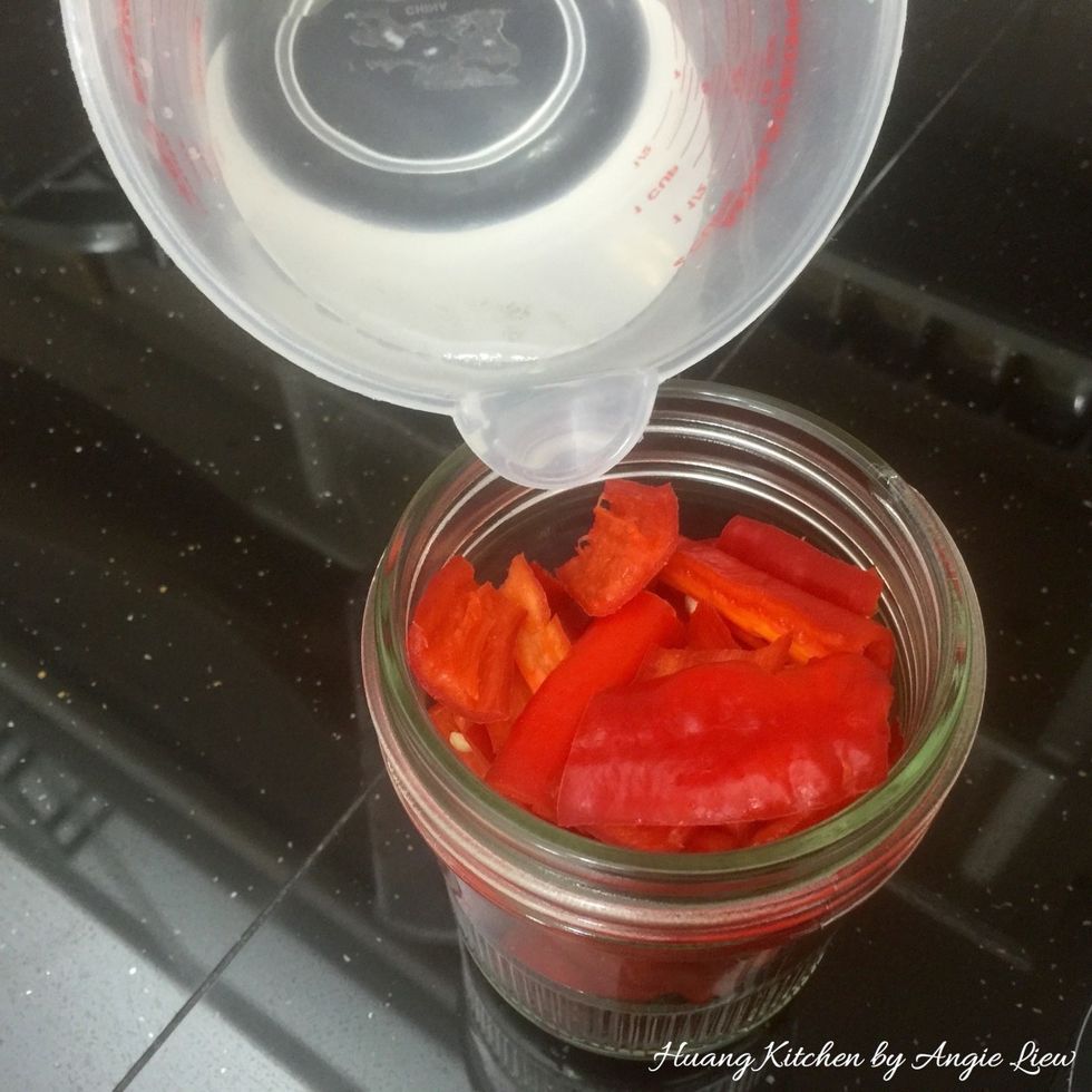 Place the cut dried and red chillies with some water added in a blender. (Ingredients to be ground {A})