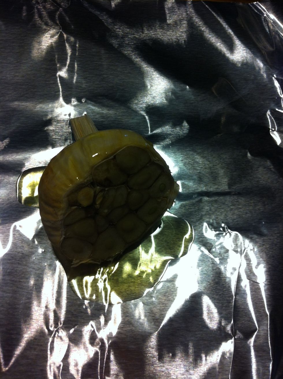 Place the cut head in the center of a square of aluminum foil and drizzle with the olive oil.