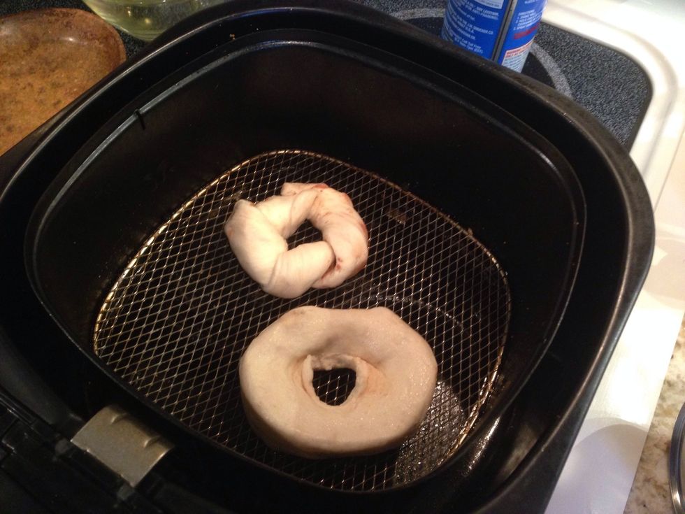 Place the donut in the air fryer with bottom lightly sprayed with oil. A regular biscuit with a hole formed in the middle makes a regular donut.