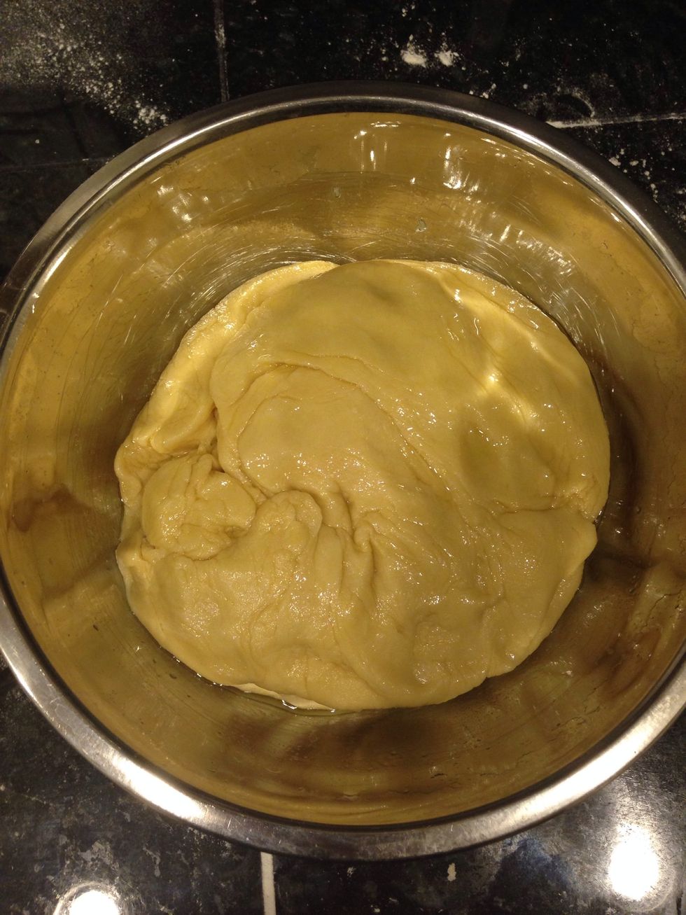 Place the dough in the bowl and turn to coat with oil.