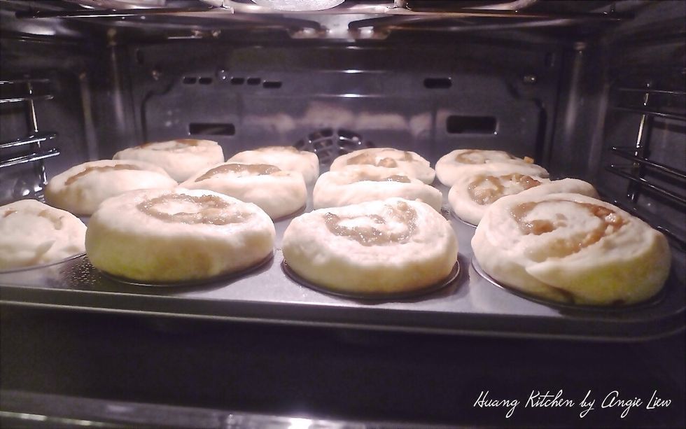 Place the dough that has risen double in size in the preheated oven. You may need to put a baking sheet underneath the muffin pan to catch any drips.
