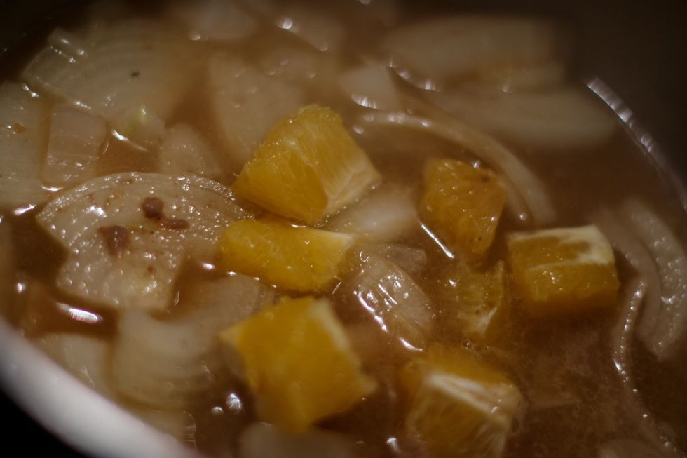 Place the drained cooking liquids, onions and citrus into a sauce pot and bring it to boil. Once boiled, reduce the heat to medium ( just boiling but not to heavily )