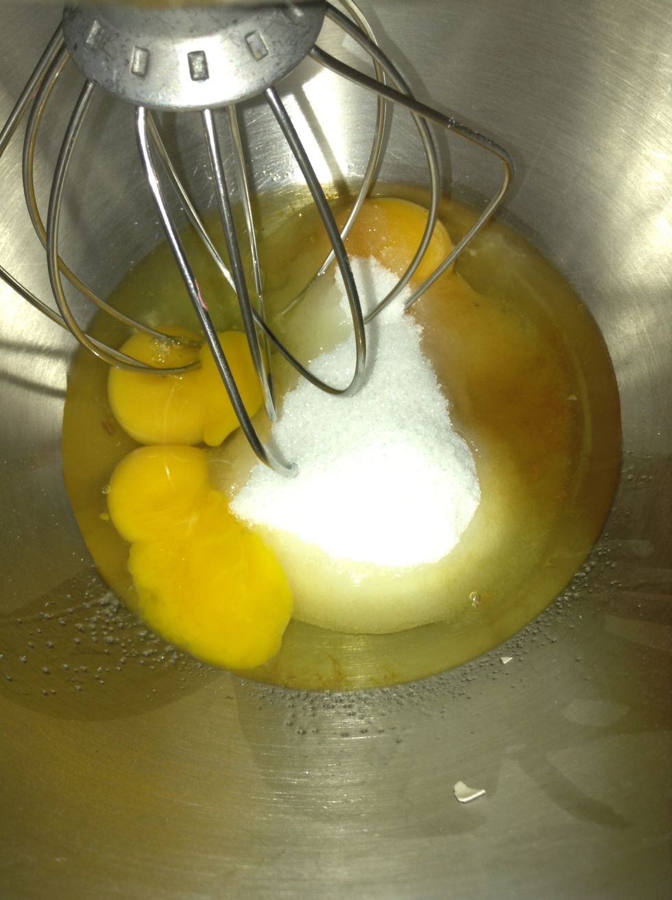 Place the eggs,egg yolk,vanilla extract,and sugar in a large bowl and whisk until very pale and thick.