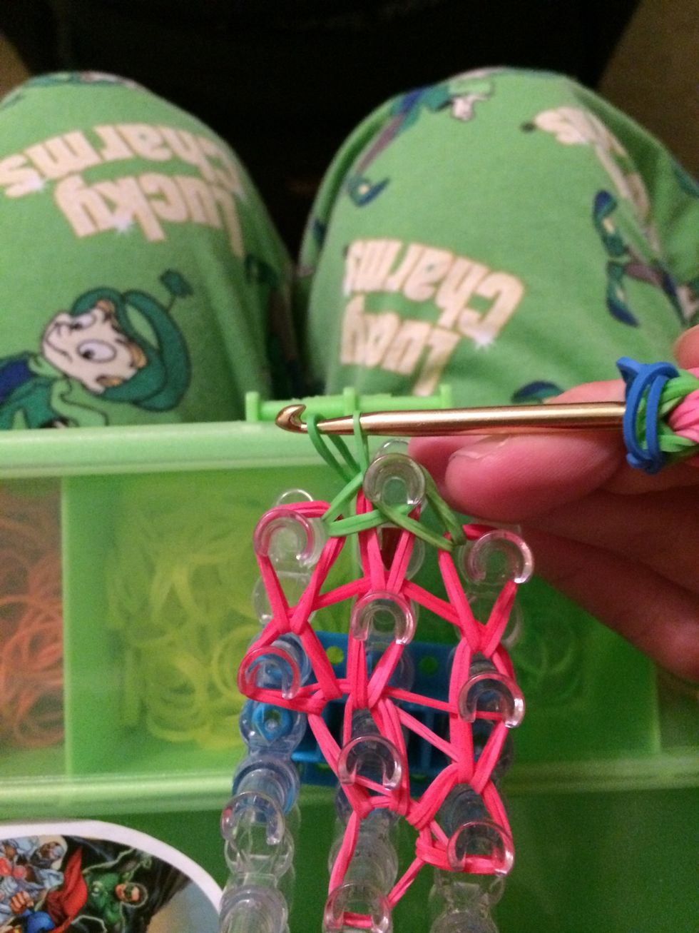 Place the end you were holding and put it on the hook. Pull the closest end (the one that was already on the hook up). Take the other end that is on the hook and pull it through.