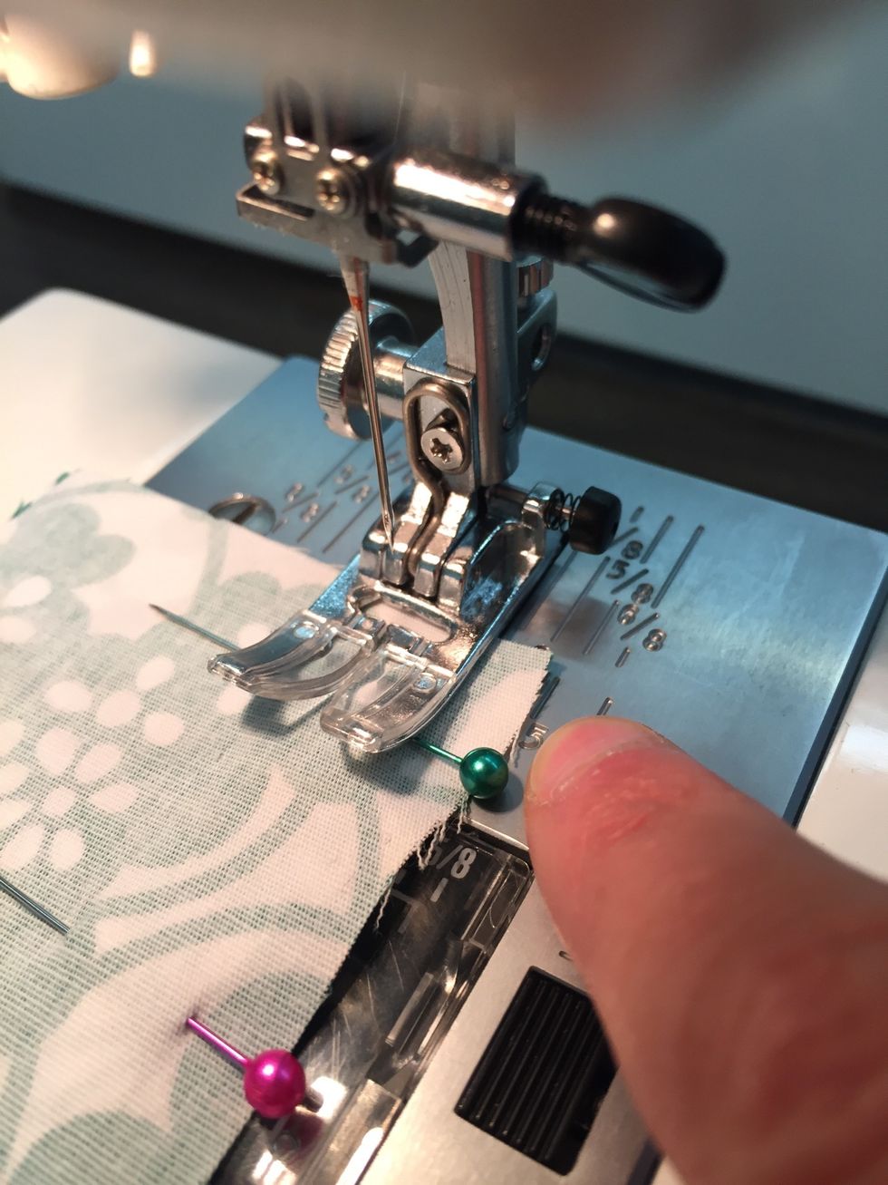 Place the fabric on the 15mm guide line and lower the presser foot.  MAKE SURE THERE IS FABRIC UNDER YOUR NEEDLE.