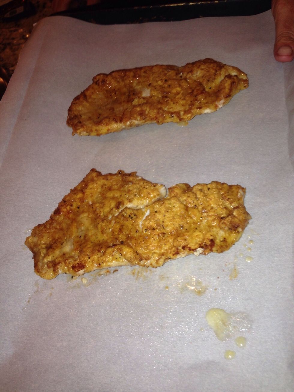 Place the fillets cooked side up on the cookie sheet and place in preheated oven. Cook until done. Set timer for about 4 - 6 minutes depending on thickness of fillets.