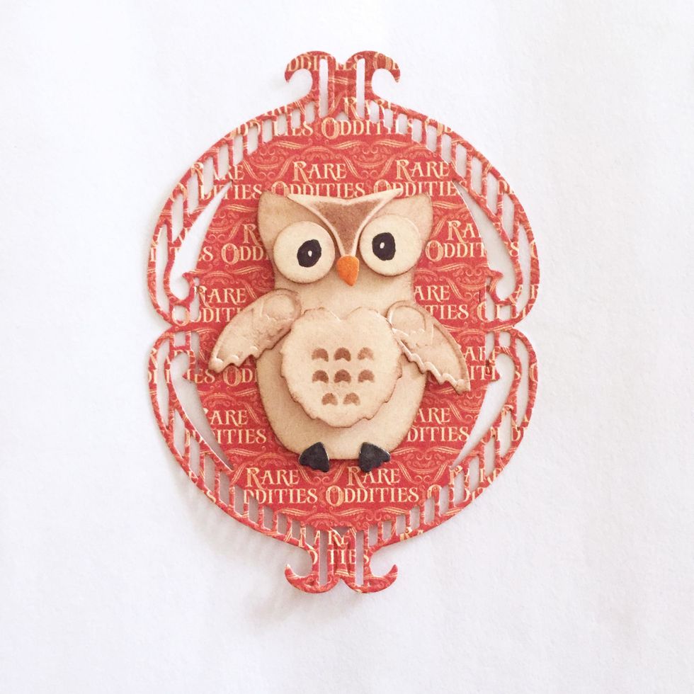 Place the finished Owl onto the piece of oval ornate piece as shown.