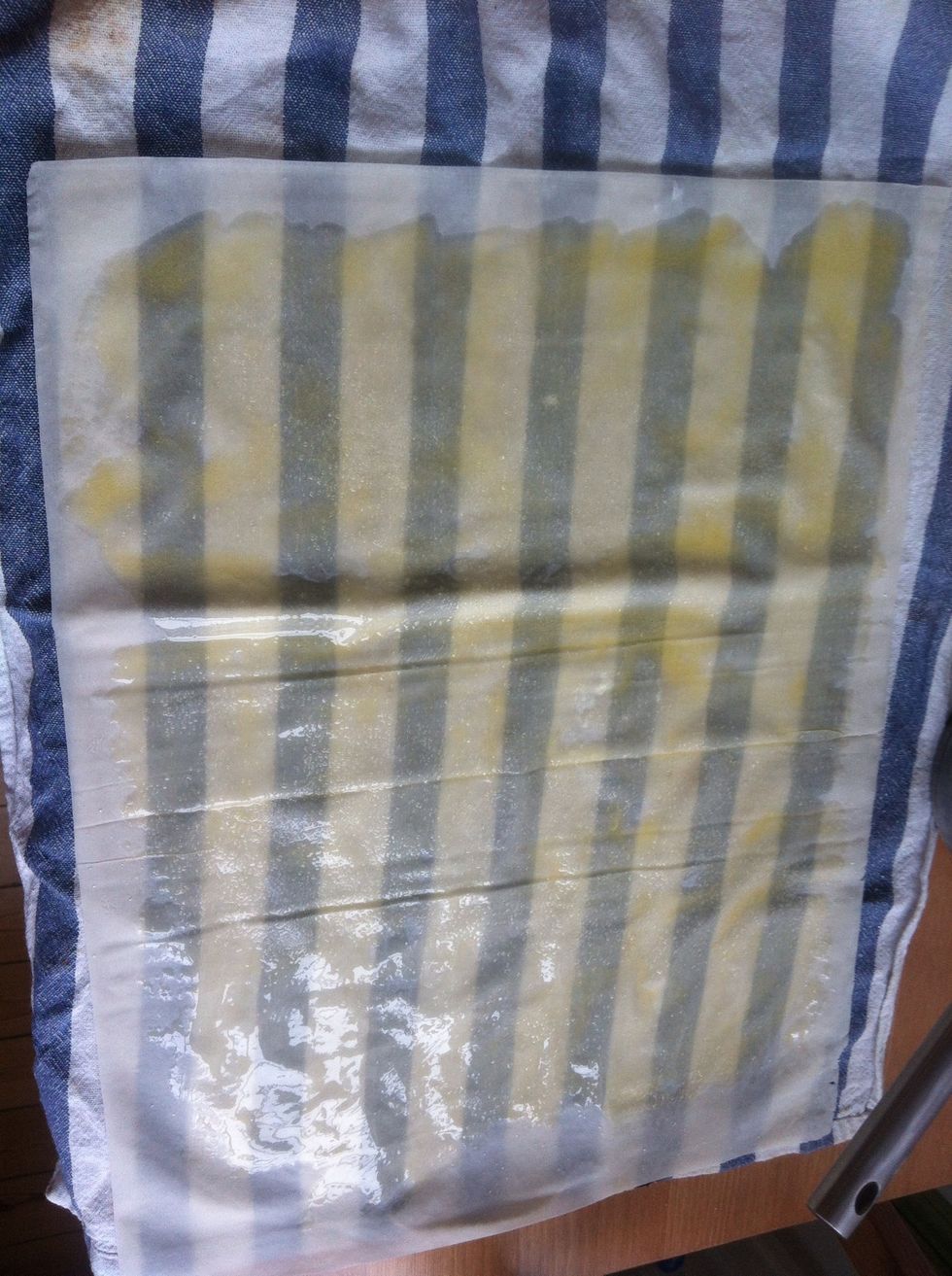 Place the first layer of phyllo dough on a moist kitchen cloth (phyllo dough dries and starts crumbling very quickly). Spread some melted butter using a brush, and sprinkle a pinch of sugar.