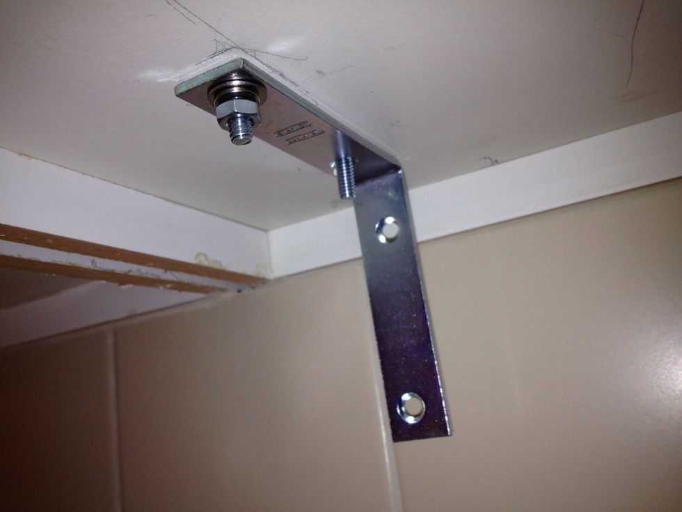 Place the flat washer, split washer and nut on the bolt and hand tighten.