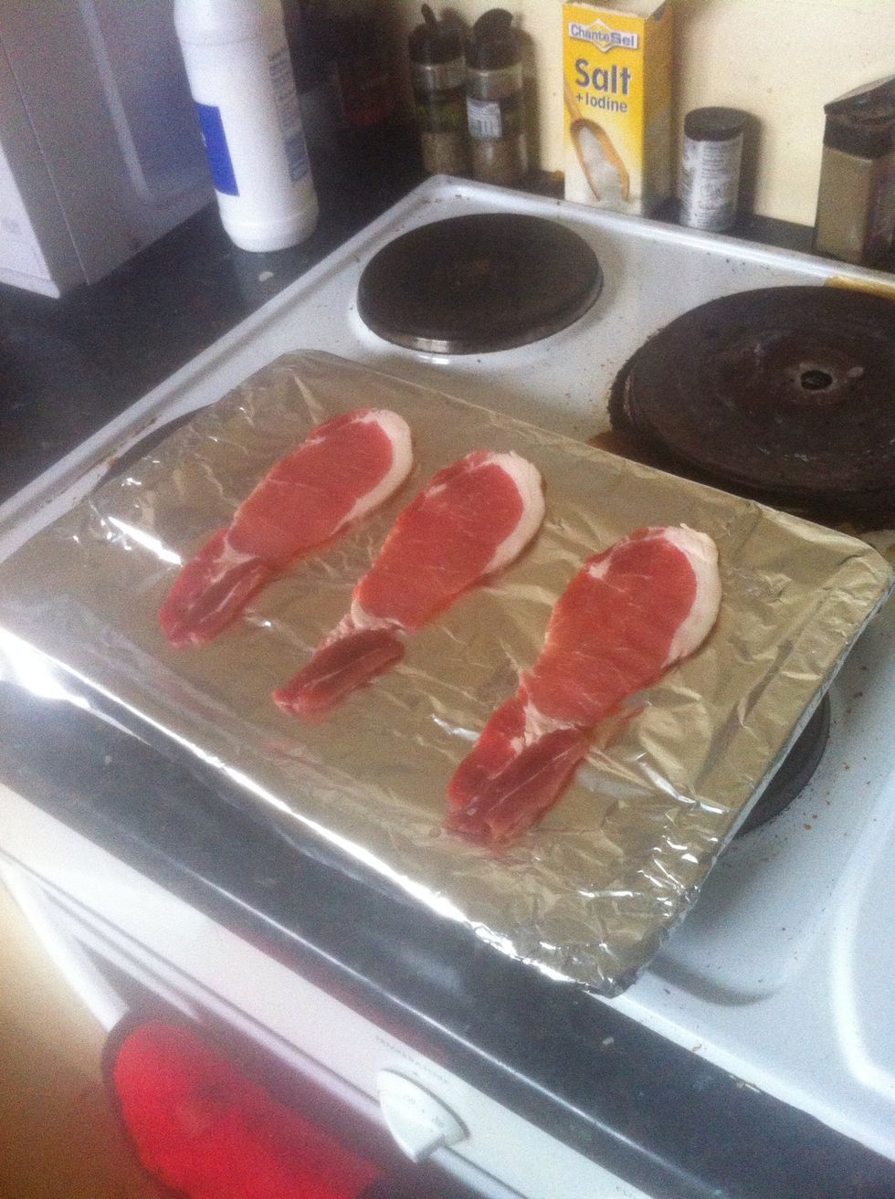 Place the foil on a baking tray (makes cleaning much easier) and place the bacon on top