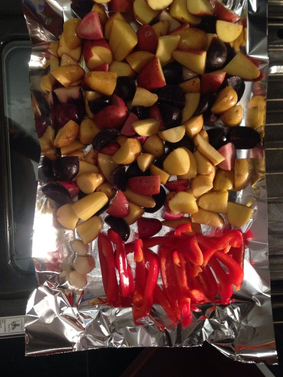 Place the garlic tomatoes and bell pepper on one side of a sheet pan - place the potatoes on the other half drizzle with olive oil salt and pepper and the rest of the paprika seasoning 22-24 min