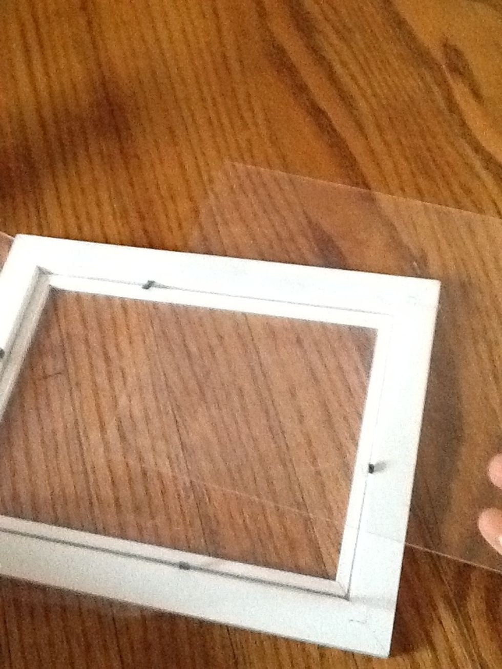 Place the glass or plastic cover ( that you got from the frame) over the mesh fabric.