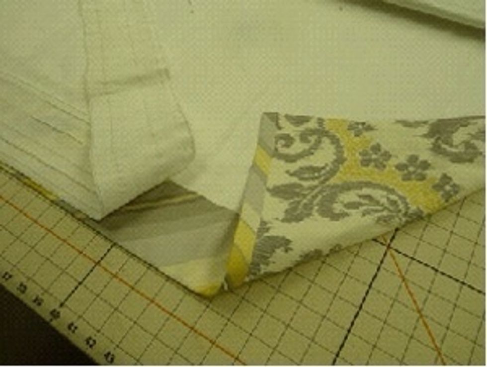 Place the Goblet Pleat tape over the back-top of the drapery panel. Follow tape instructions for placement of the repeat indicating dots to center the tape.